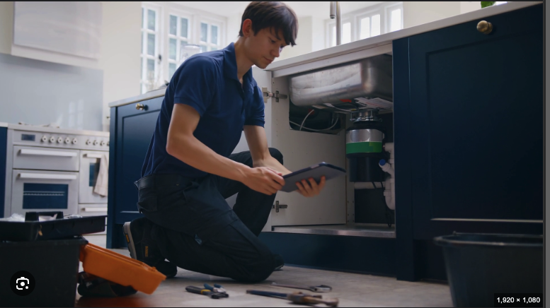 Plumber fixing sink